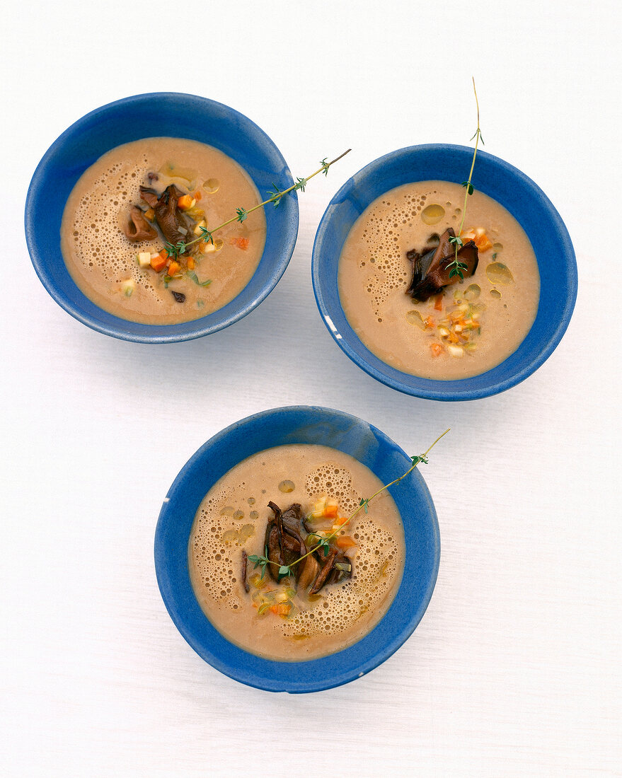 Porcini mushroom and potato soup in three bowls