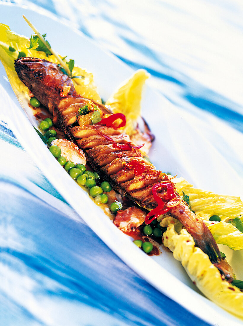 Deep-fried hake with lemon grass and soy marinade on plate