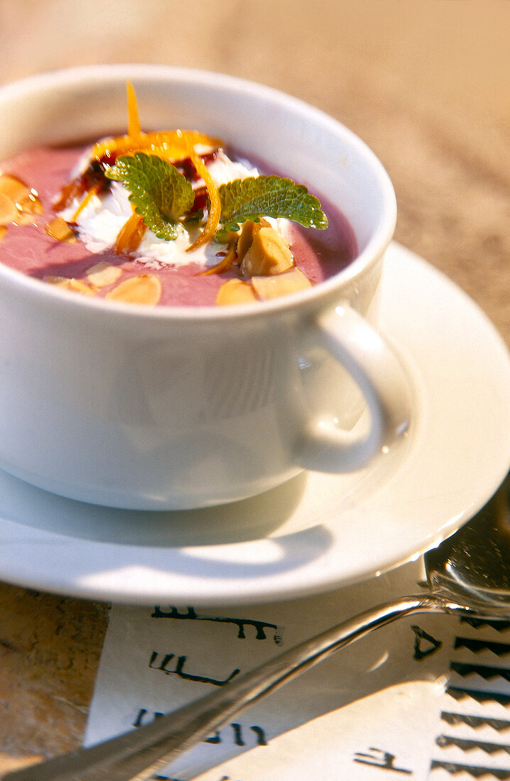 Close-up of blackberry cream soup in cup