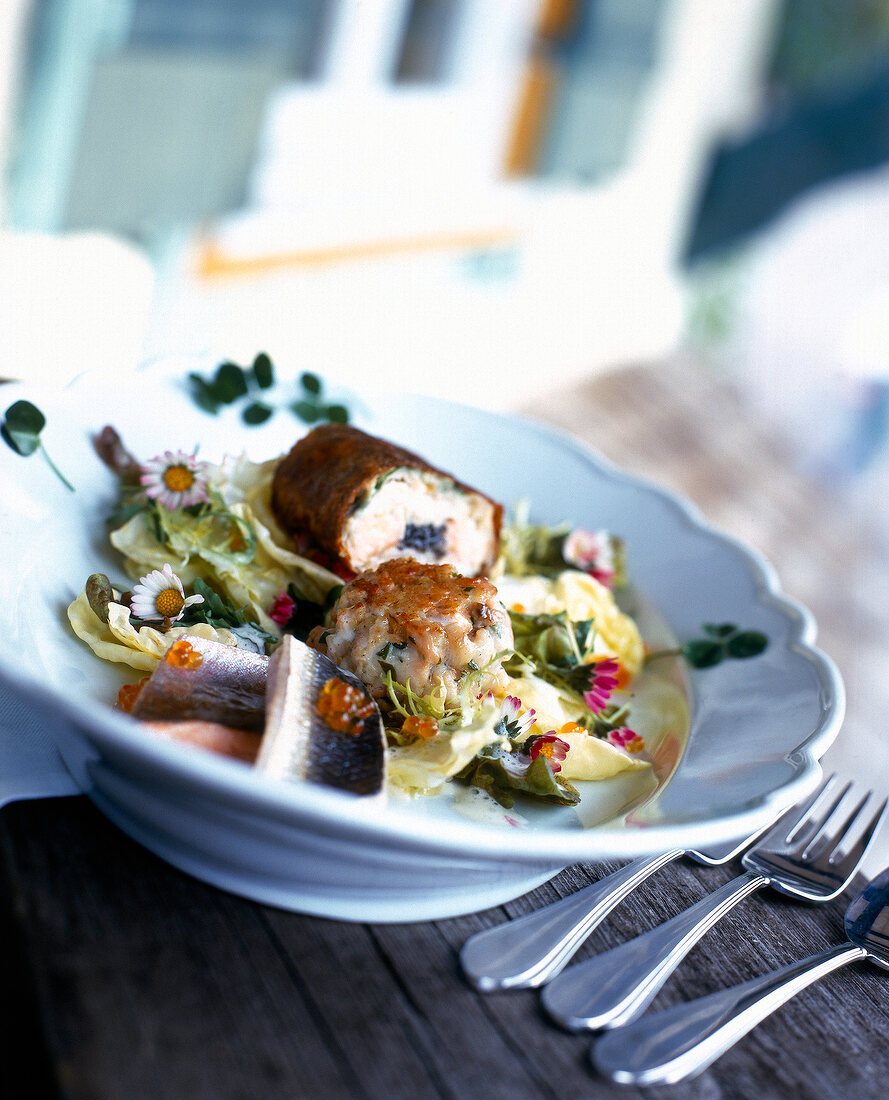 Close-up of green salad with char and whitefish in bowl