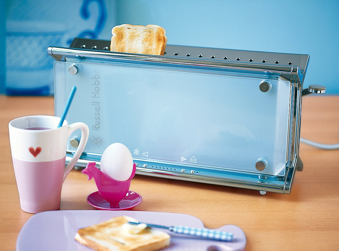 Frühstückstisch mit Ei, Toaster und Toastbrot