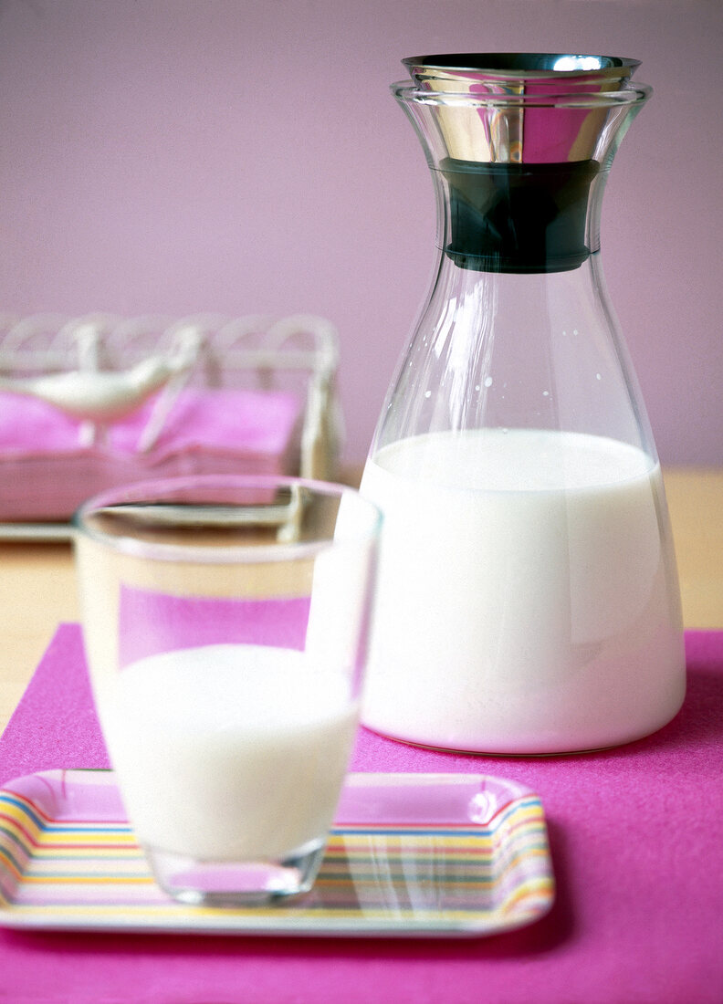 Close-up of milk in carafe and glass