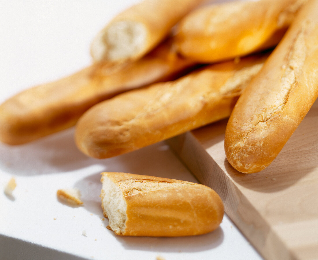 Close-up of various baguette bread on chopping board