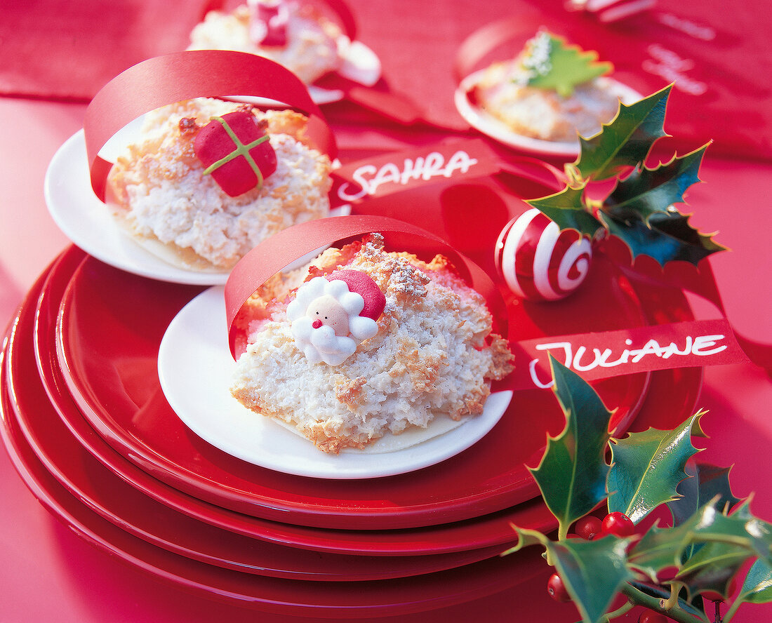 Coconut macaroons on festive table with cards and decoration