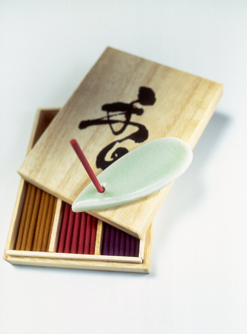 Box with Japanese incense placed on white background