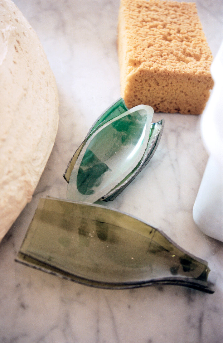 Sawing glass bottles in workshop