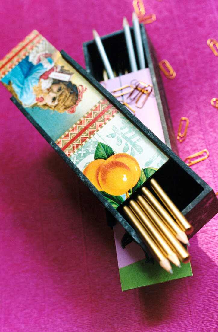 Close-up of wooden pencil boxes with pencils