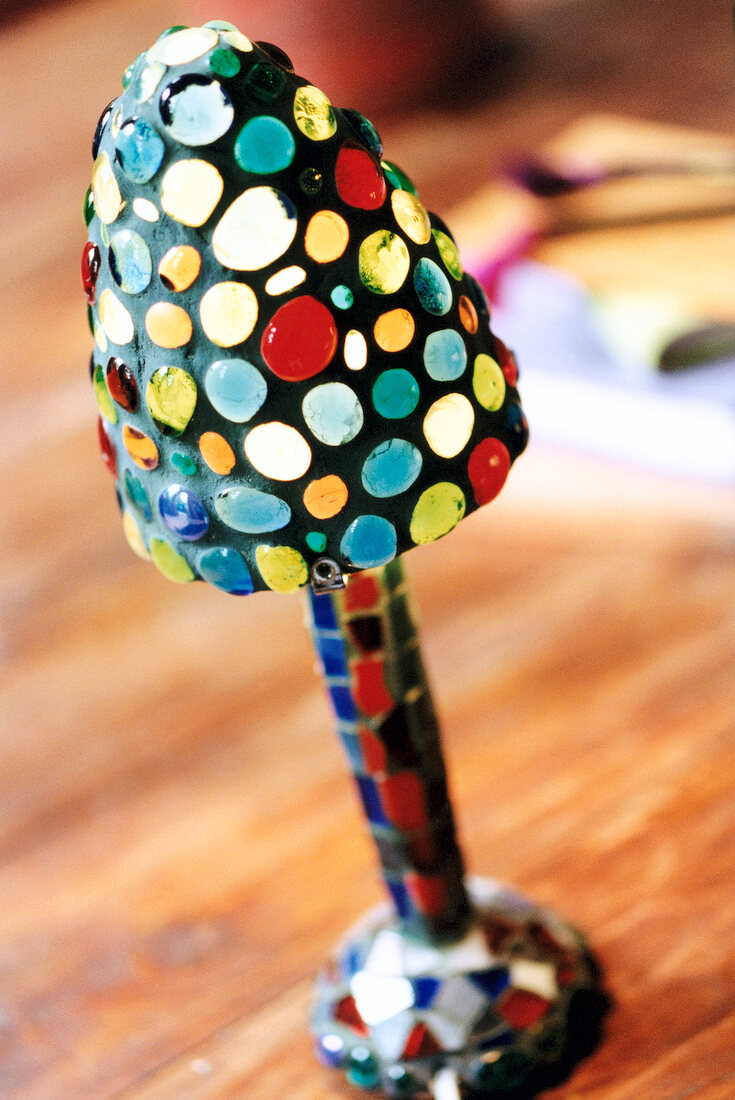 Close-up of multi-coloured mushroom lamp made of glass balls and mosaic tiles