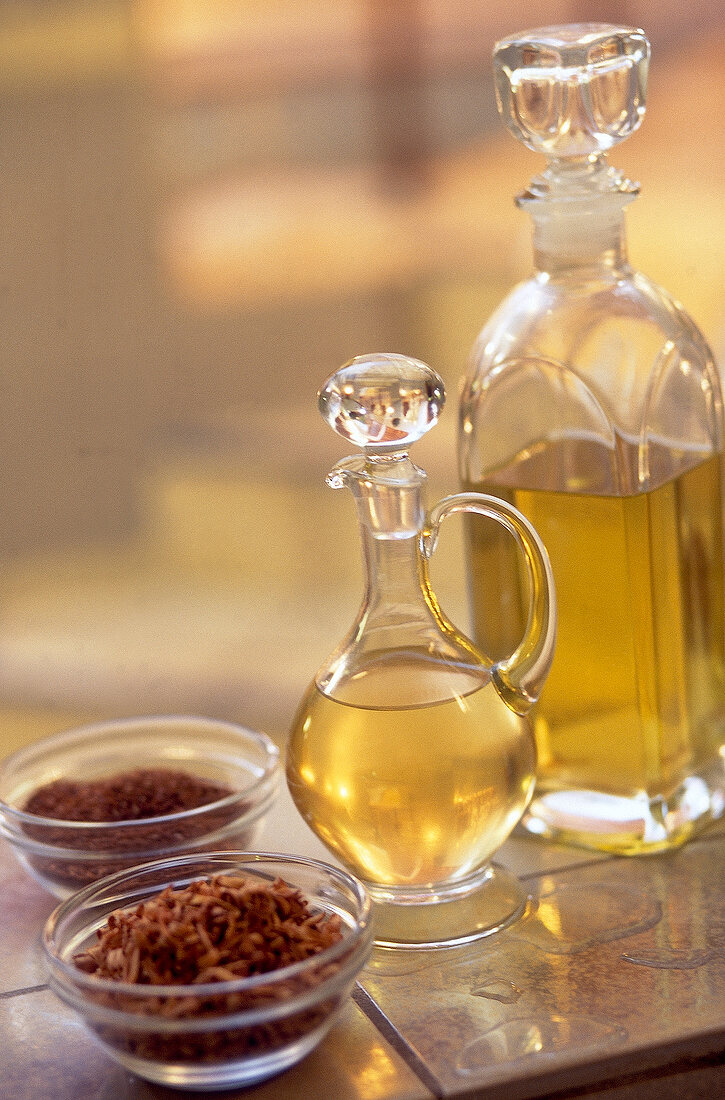 Scented bath products - Bowls of herbal rose petals and oils jars arranged on table