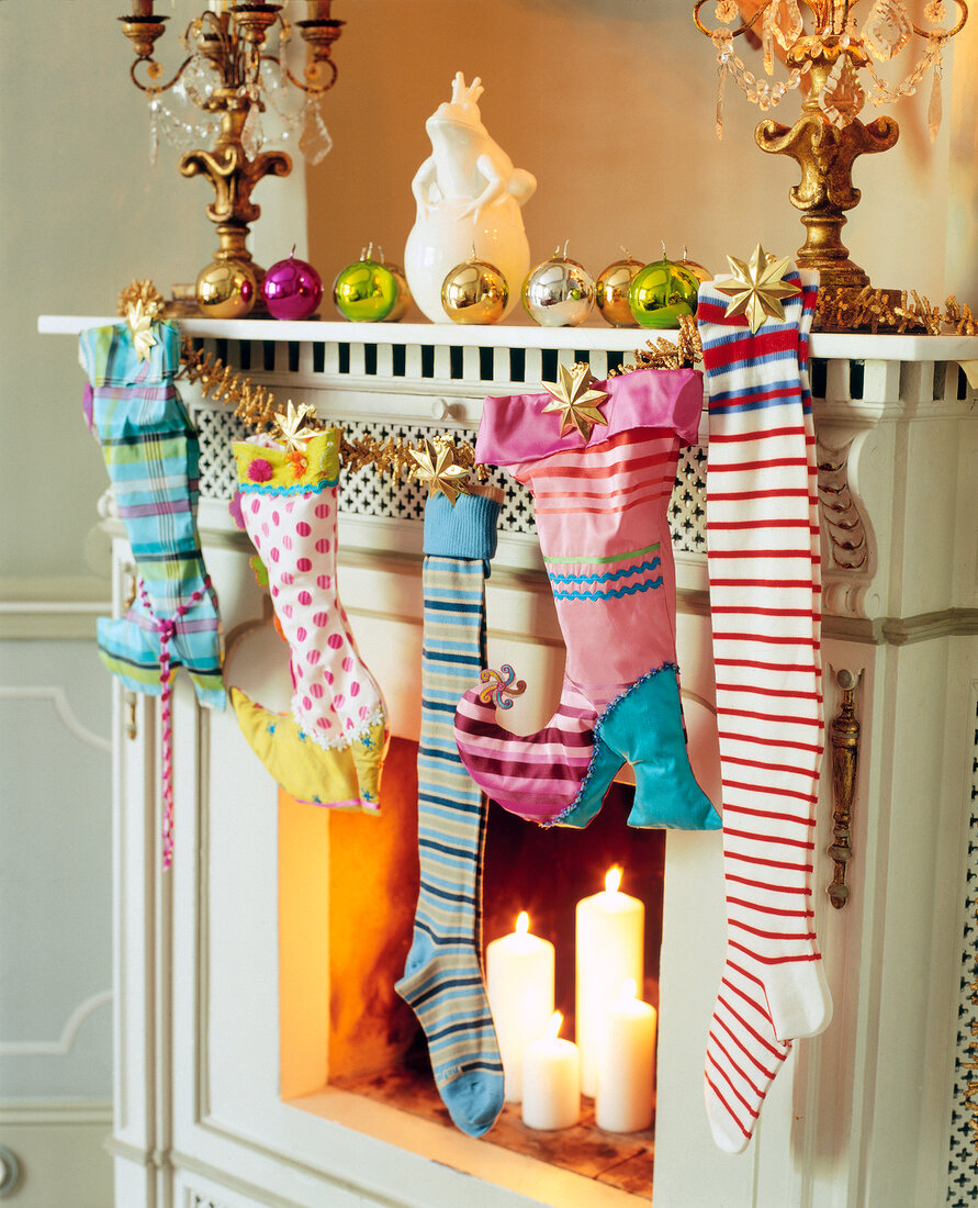 Christmas socks hanging on mantelpiece decorated for Christmas