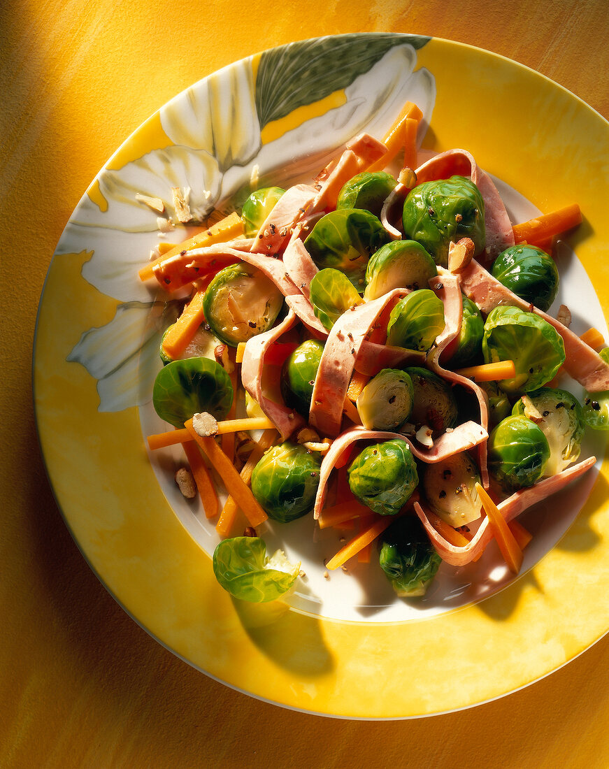 Brussels sprouts salad with walnut dressing on plate