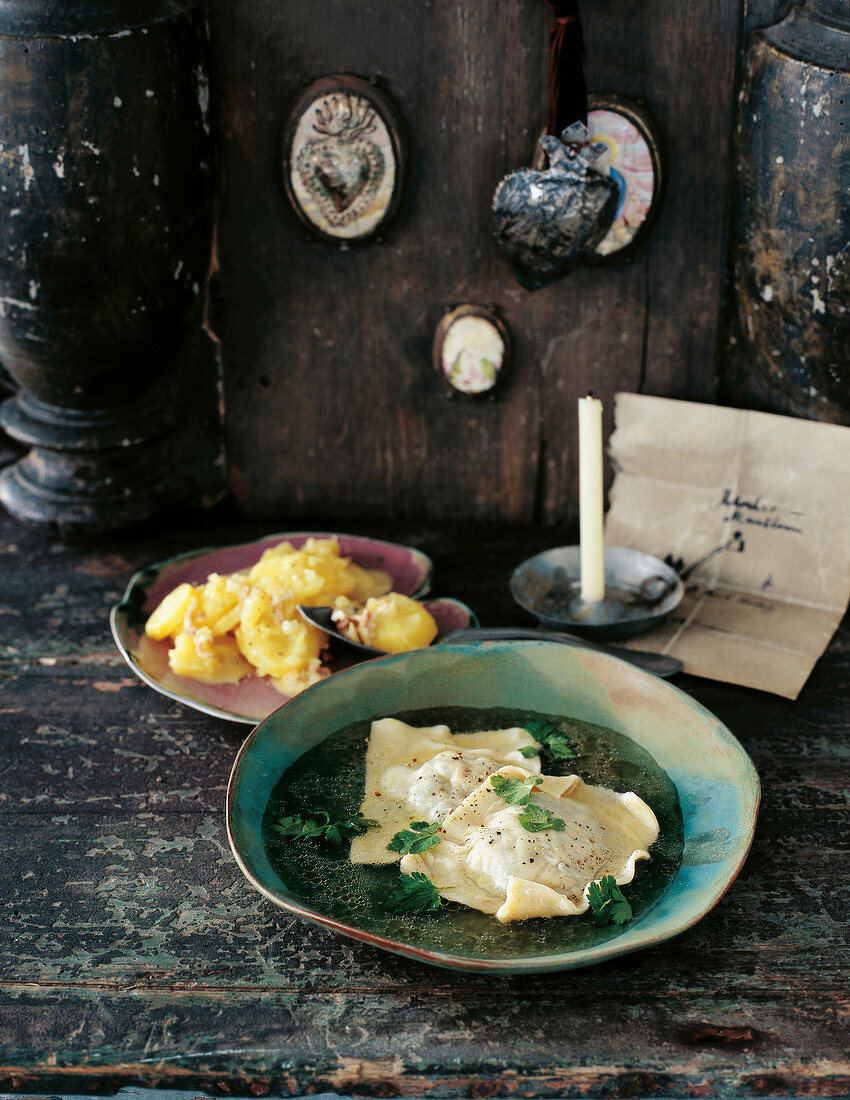 Dumplings with beef broth in serving dish