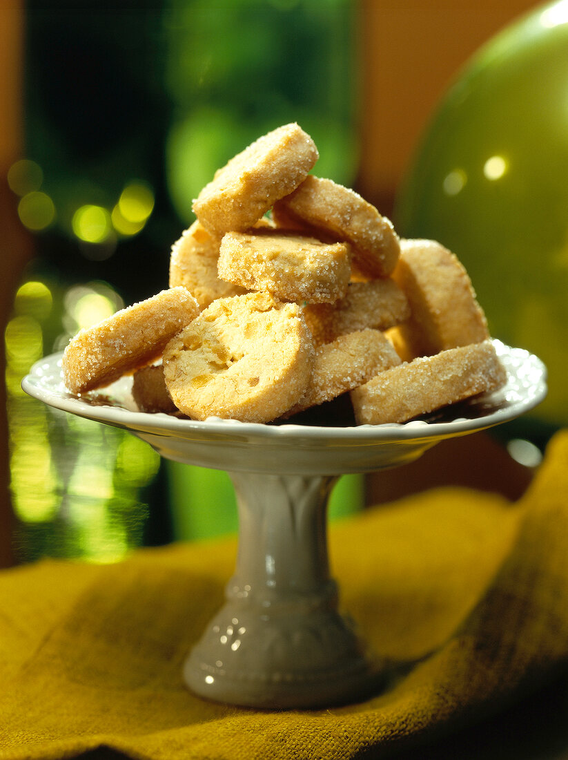 Slices of pine and orange cake with sugar on cake stand