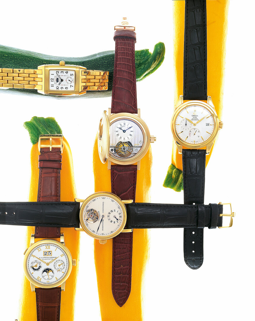 Variety of luxury wrist watches on white background