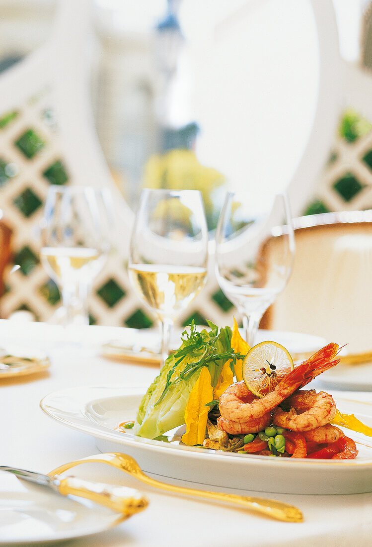 Prawns with tomato and bean seeds on plate