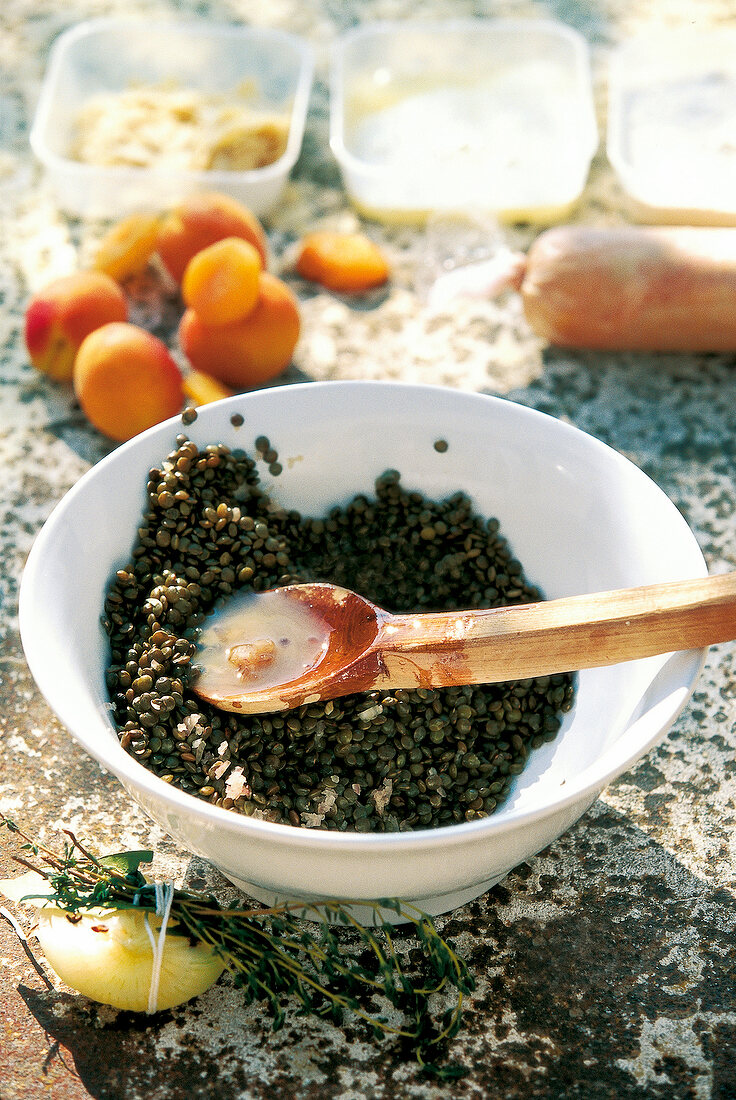 Preparation of pay lentils in bowl with wooden spoon