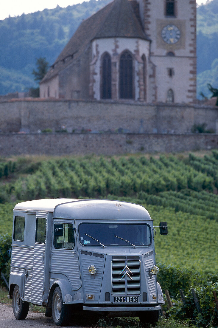 Landscape of wines in Alsace with small van on country road