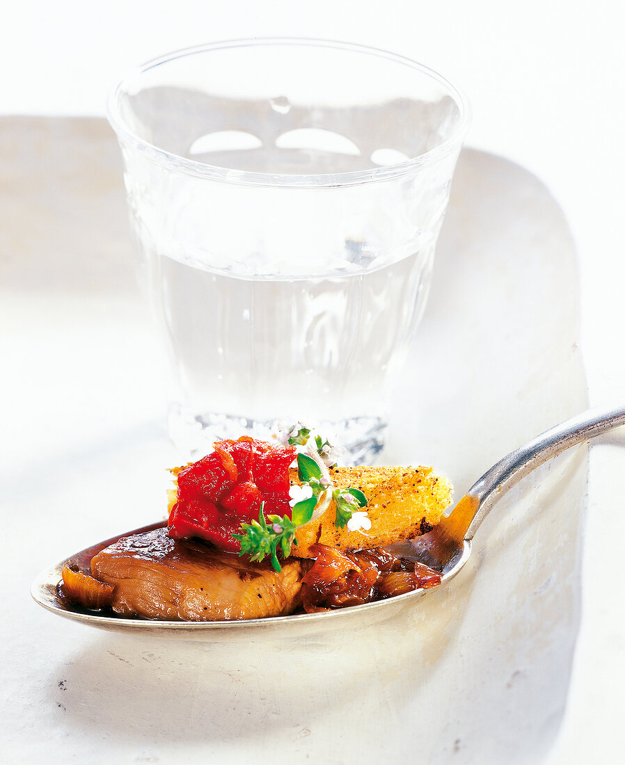 Close-up of lamb fillet, tomato jam, toast and buckwheat honey in spoon