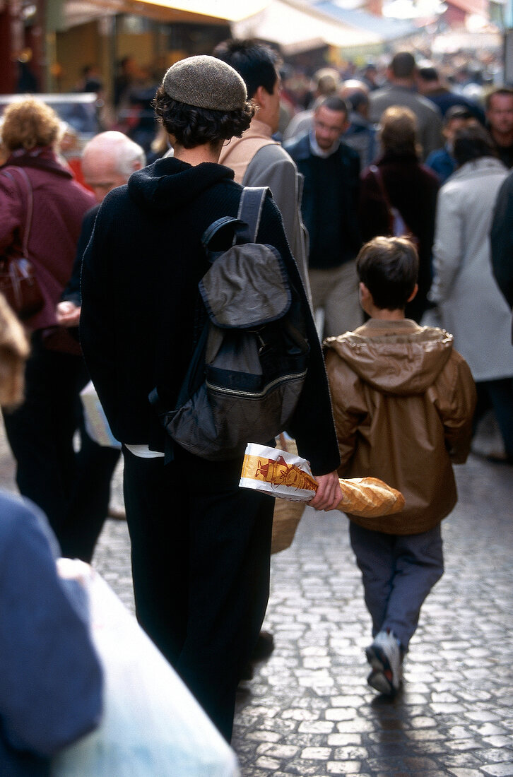 People walking on Rue Mouffetard street in Paris, France