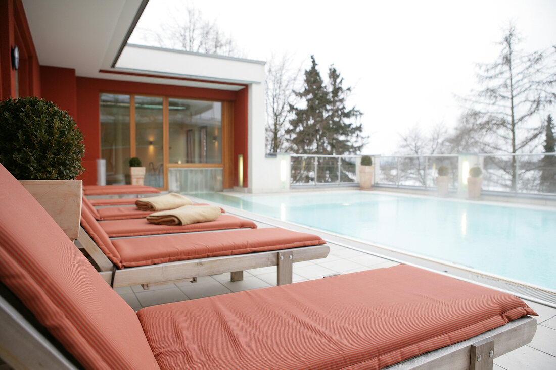 Empty deck chair at swimming pool in Vital Hotel