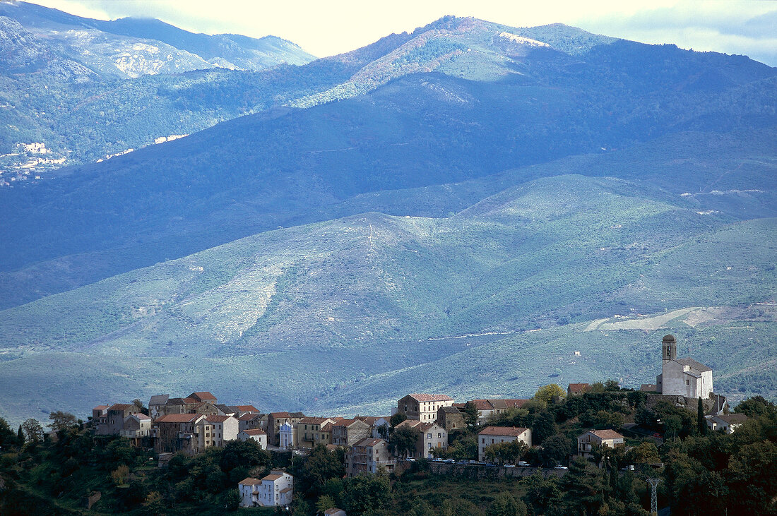 View of Poggio de Venaco village between mountains in Corsica, France