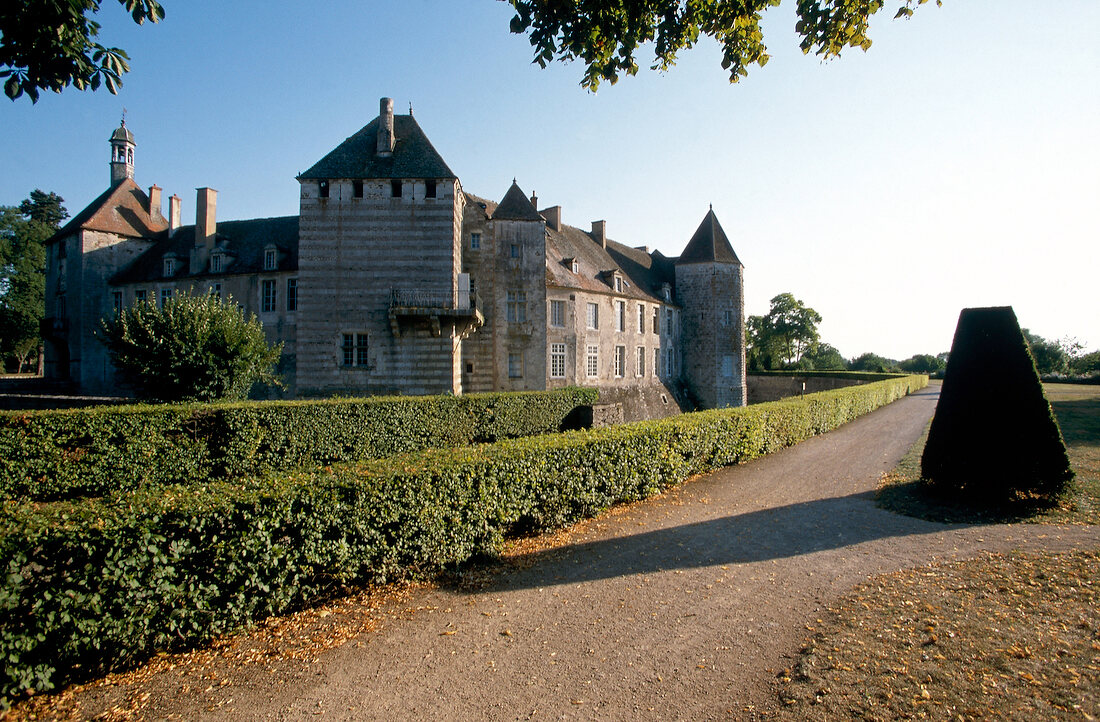 Castle of Epoisses with hedges around it and sunlight falling on it, Burgundy, France