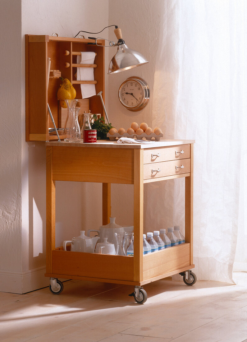 Butcher block made of beech wood with hinged worktop surface and wall clock on side