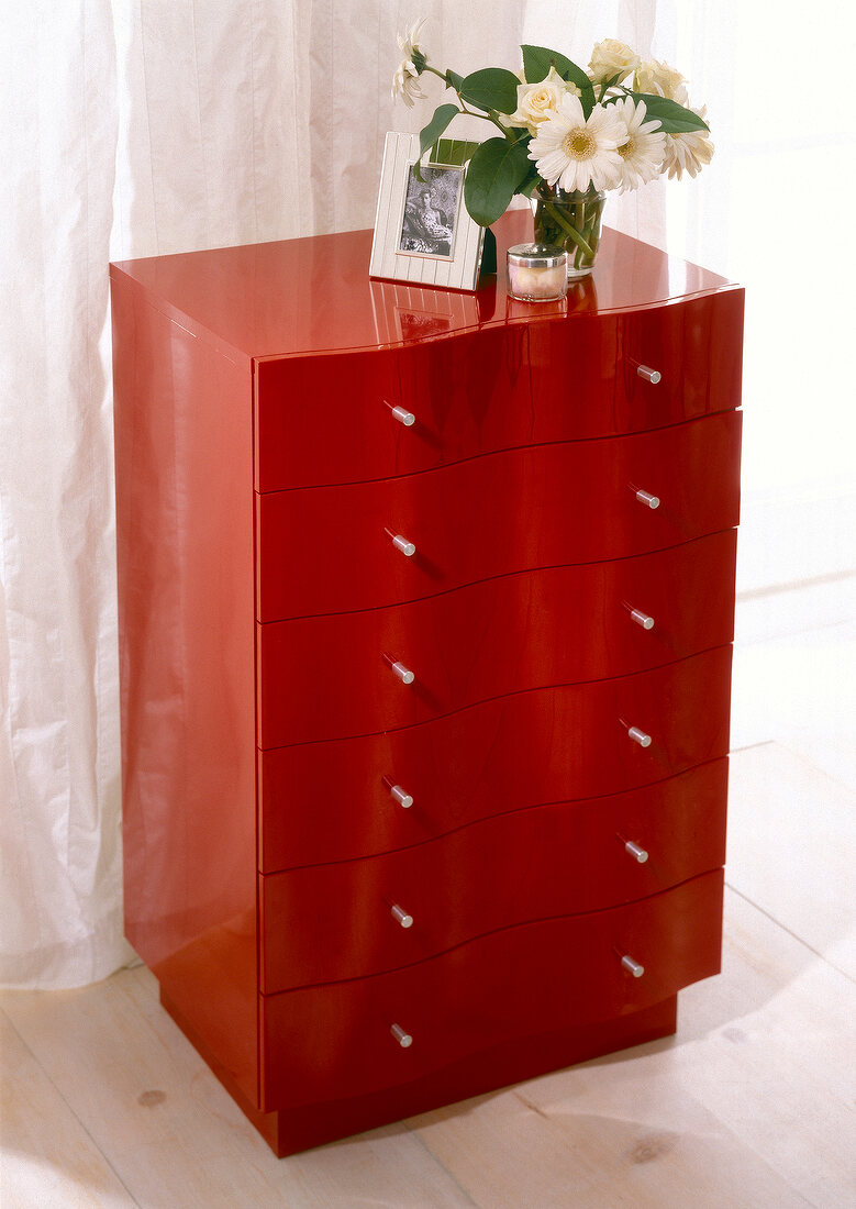 Japanese red lacquered chest of drawers with wavy drawer front