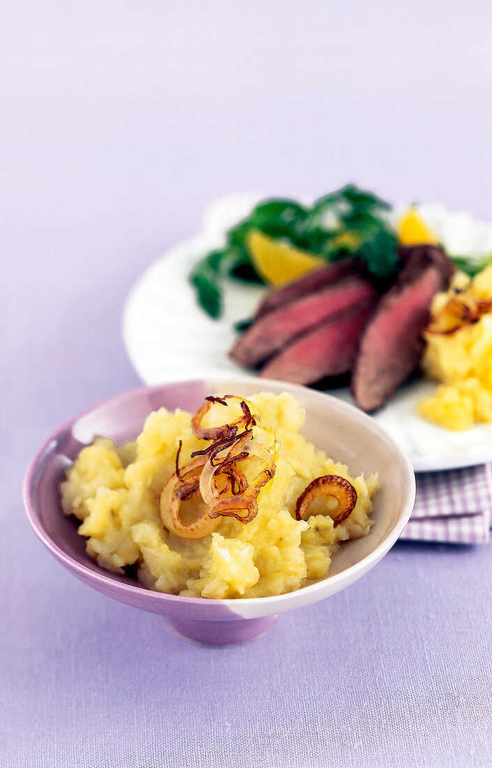 Celery beet puree with caramel onions in bowl