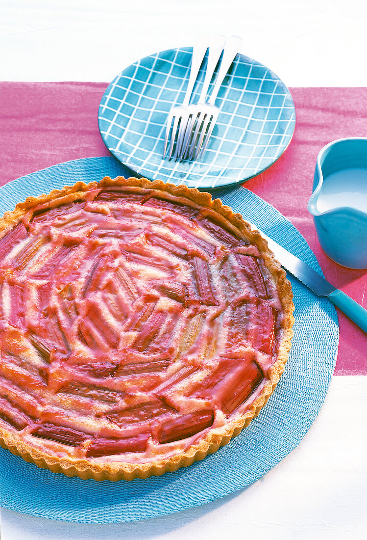 Rhubarb and vanilla tart next to three forks on table