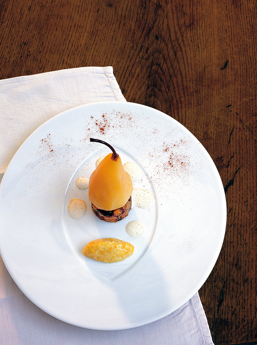 Pears with dried fruit on white plate