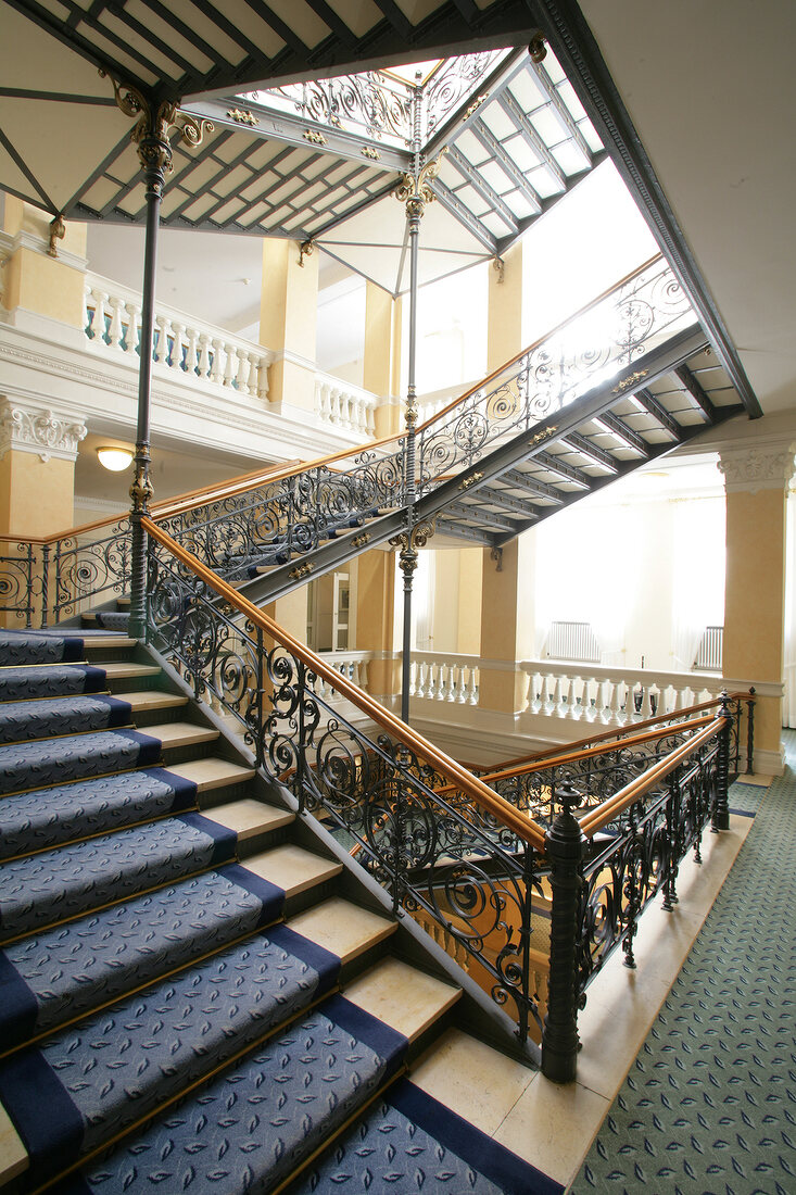 View of staircase with ornamental railings at hotel in Germany