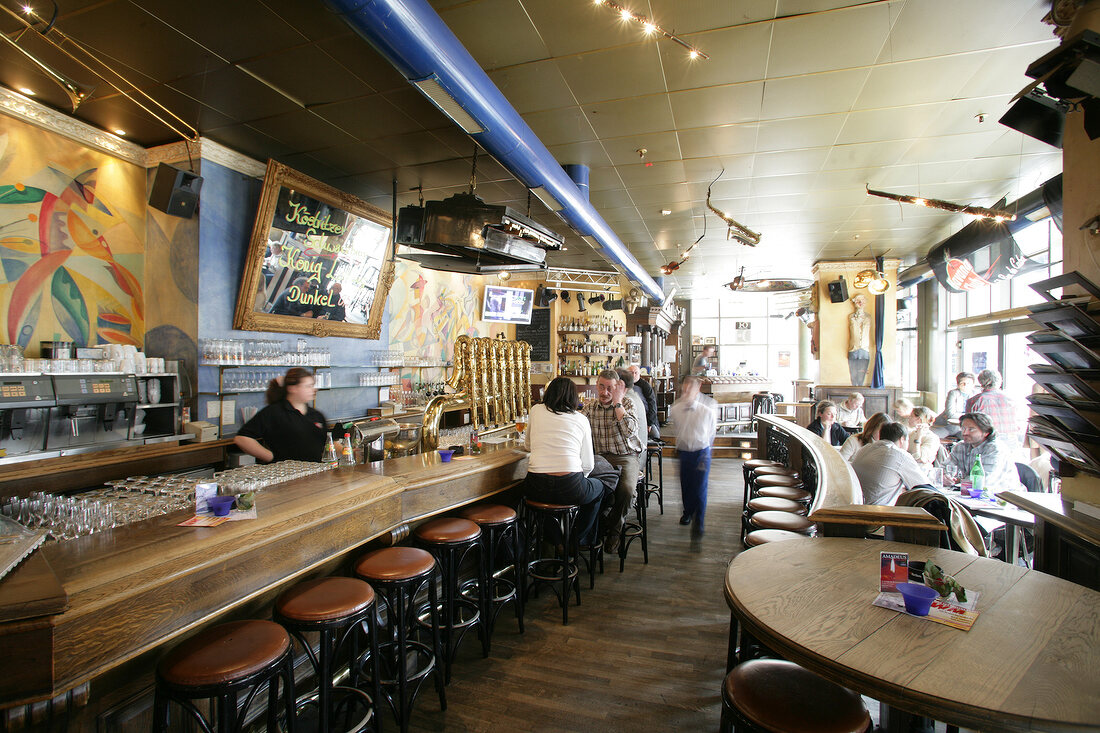 People sitting at bar counter in restaurant, Germany