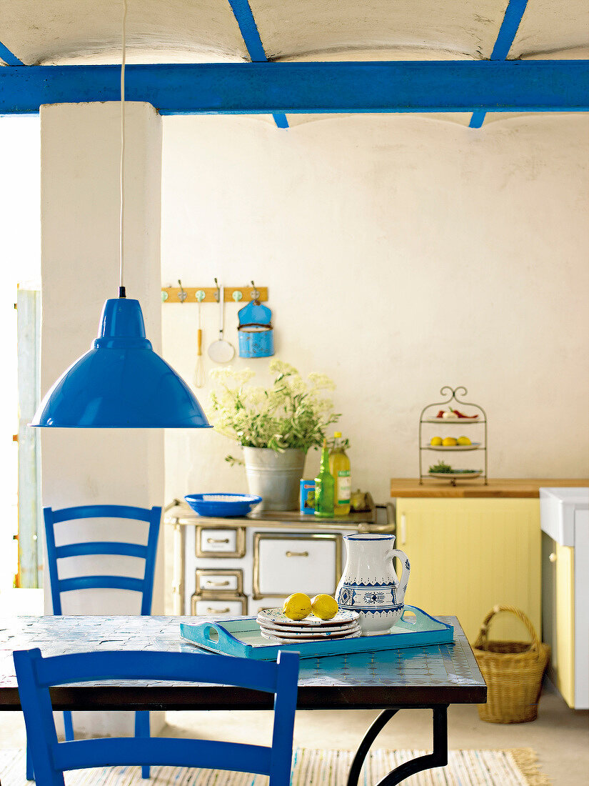 Kitchen with blue furniture and beam