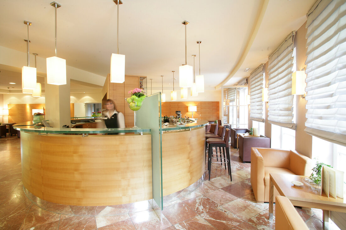 Woman at reception area of hotel, Austria