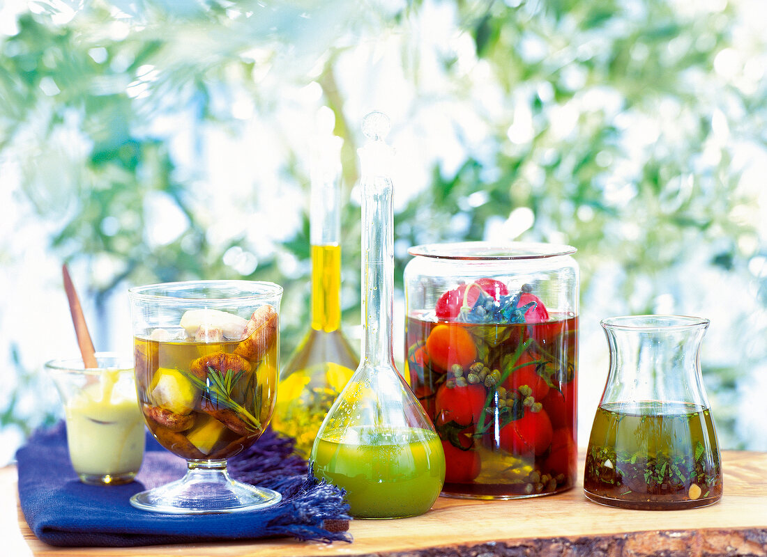 Olive oil, aioli and mint vinaigrette with vegetables in glass jars