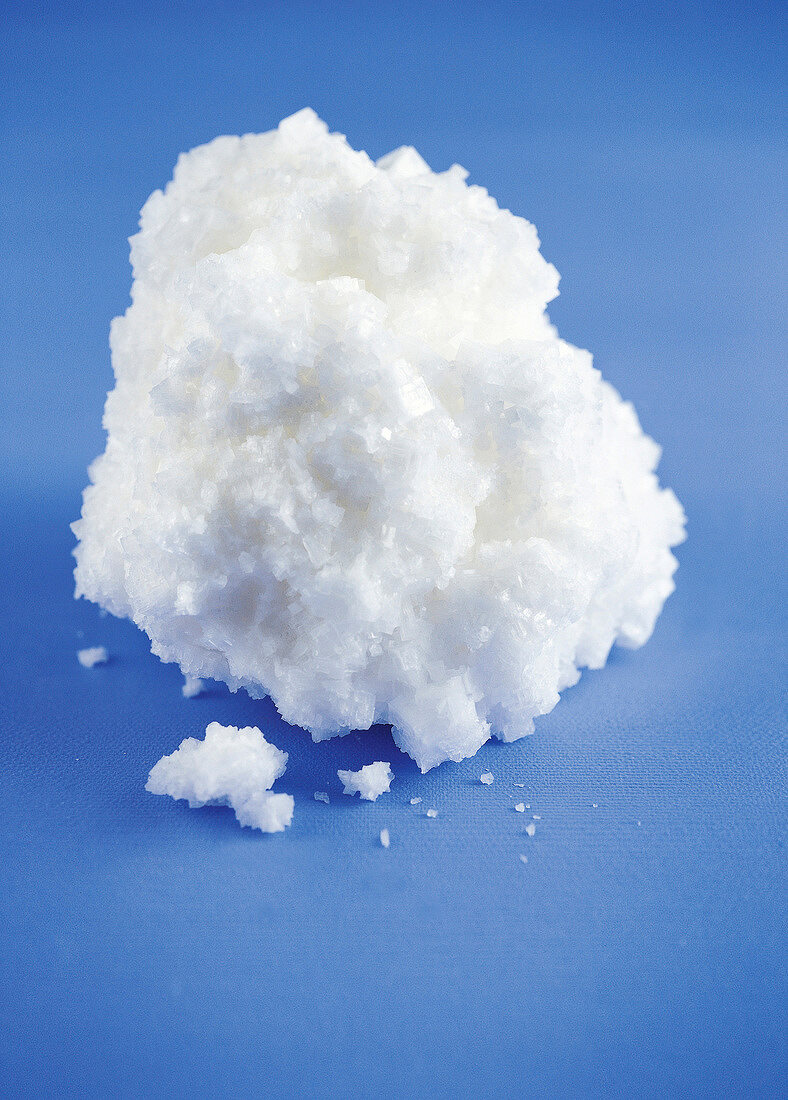 Close-up of salt crystals on blue background