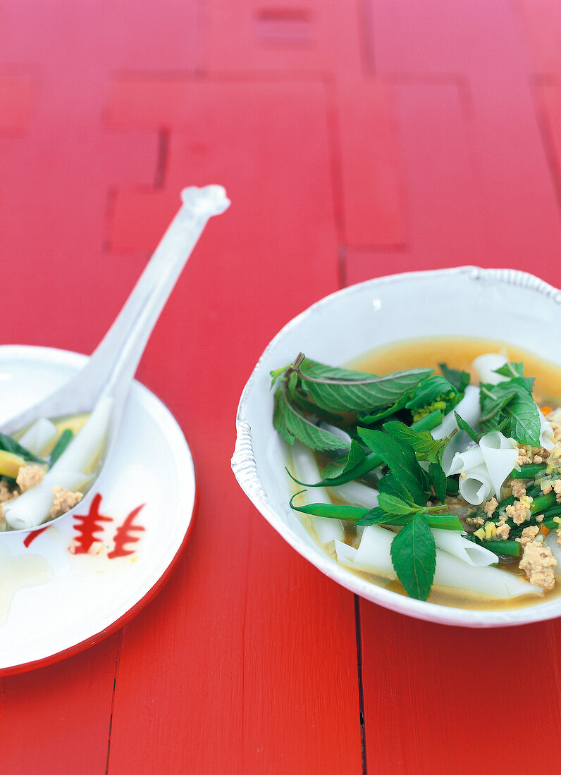 Close-up of Thai noodle soup garnished with herbs