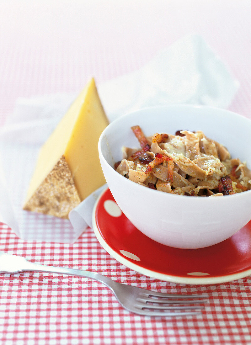 Pasta with bacon and cheese served in bowl