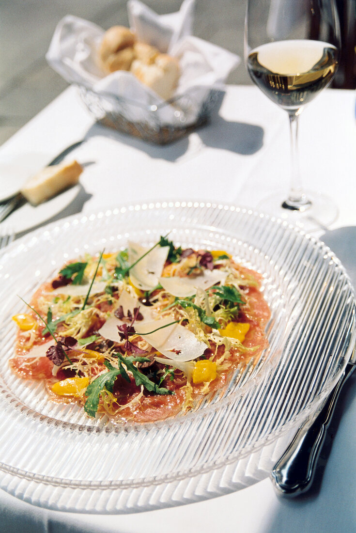 Carpaccio of beef served on glass plate