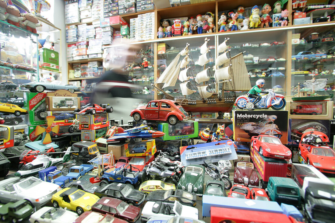Various types of toy cars in shop, blurred motion