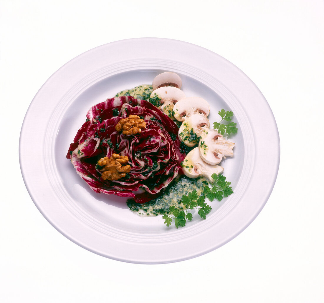 Radicchio salad with mushrooms and walnuts on plate