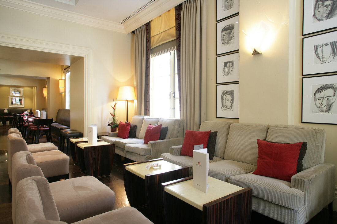 Interior of hotel with picture frames, tables and chairs, Belgium