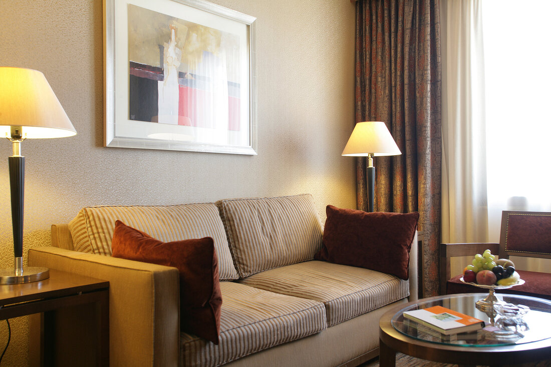 Hotel's room with lamp, wall painting and sofa, Belgium