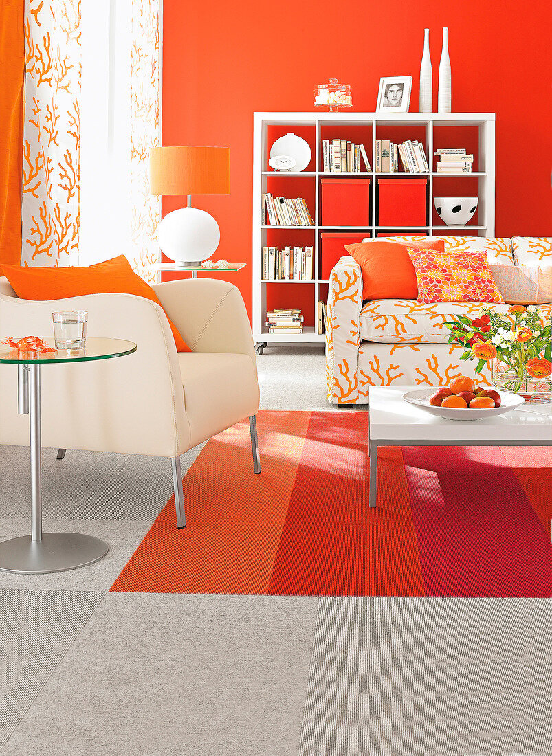 Orange walls and carpet with bright chair and sofa in living room