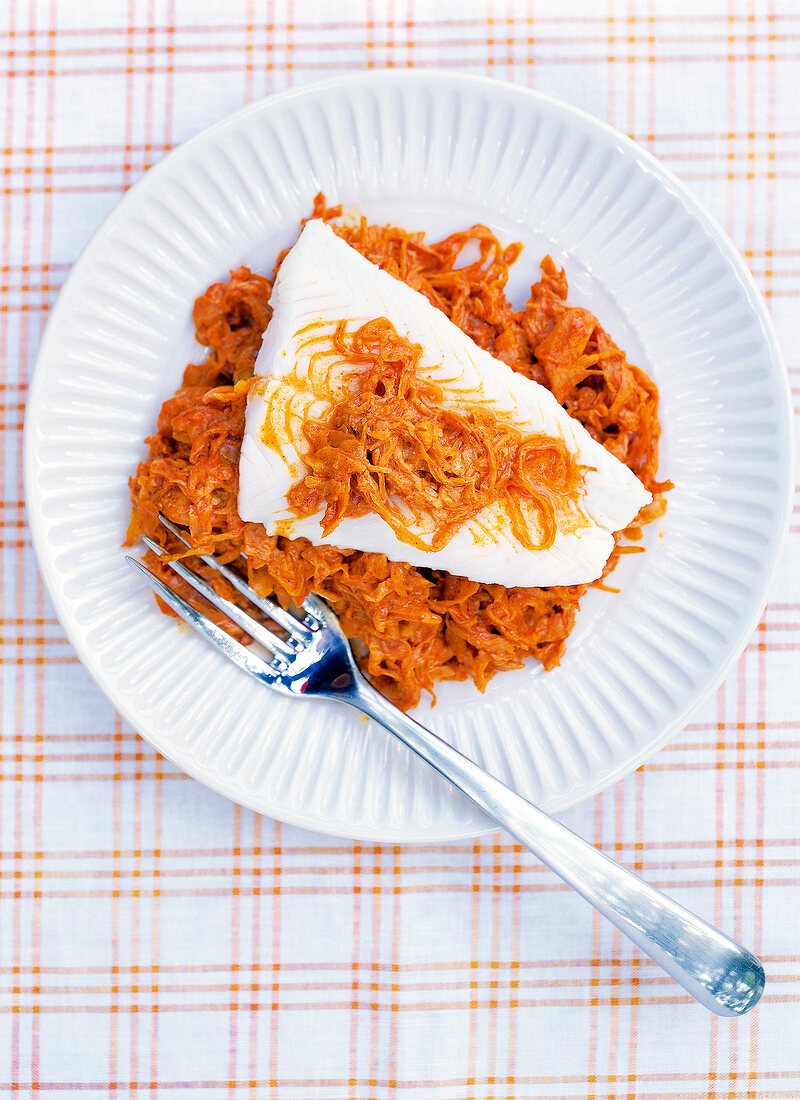 Sauerkraut with zander fillet on white plate