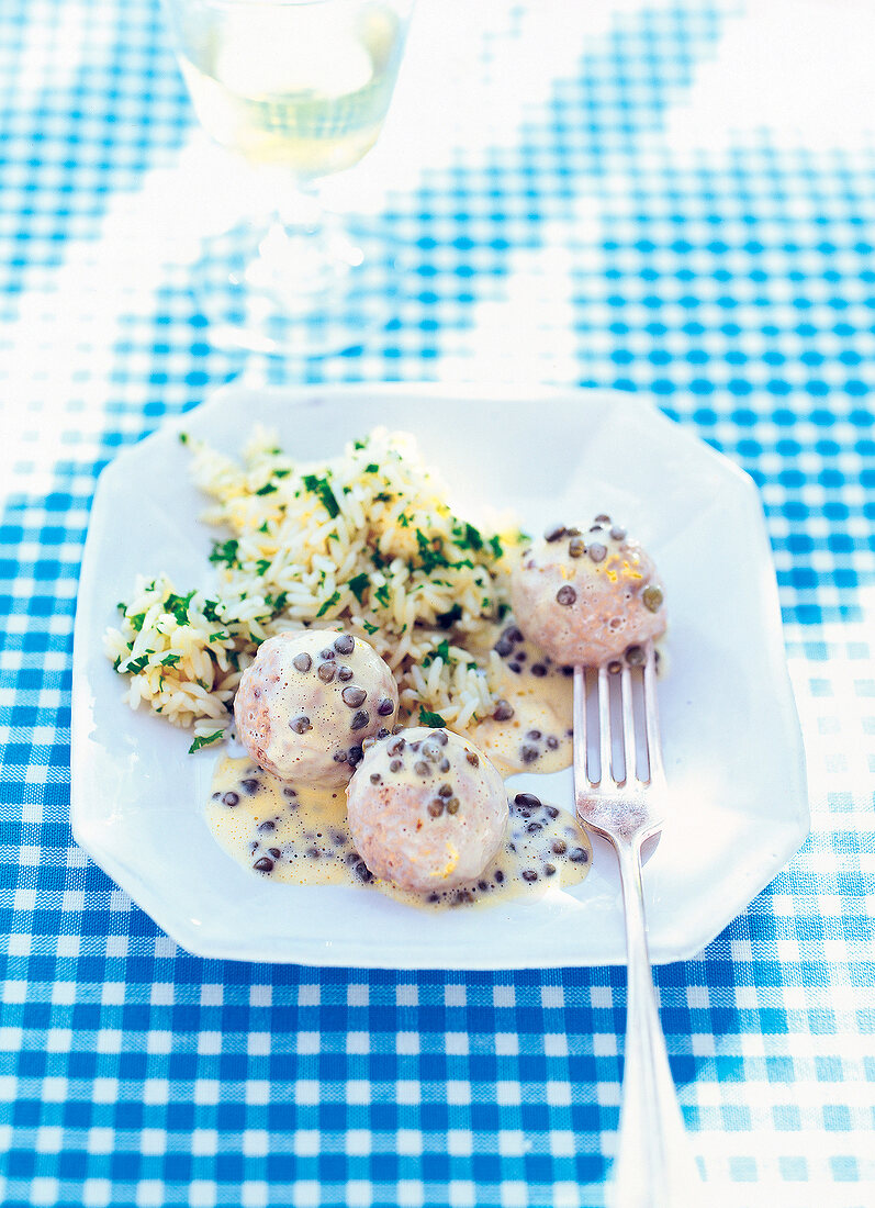 Meatballs with caper sauce on plate