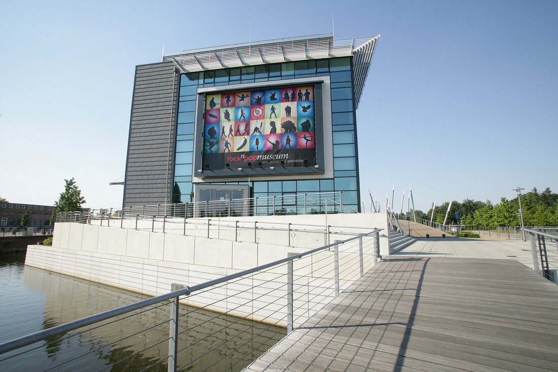 Modern exterior of hotel with hoarding and railing