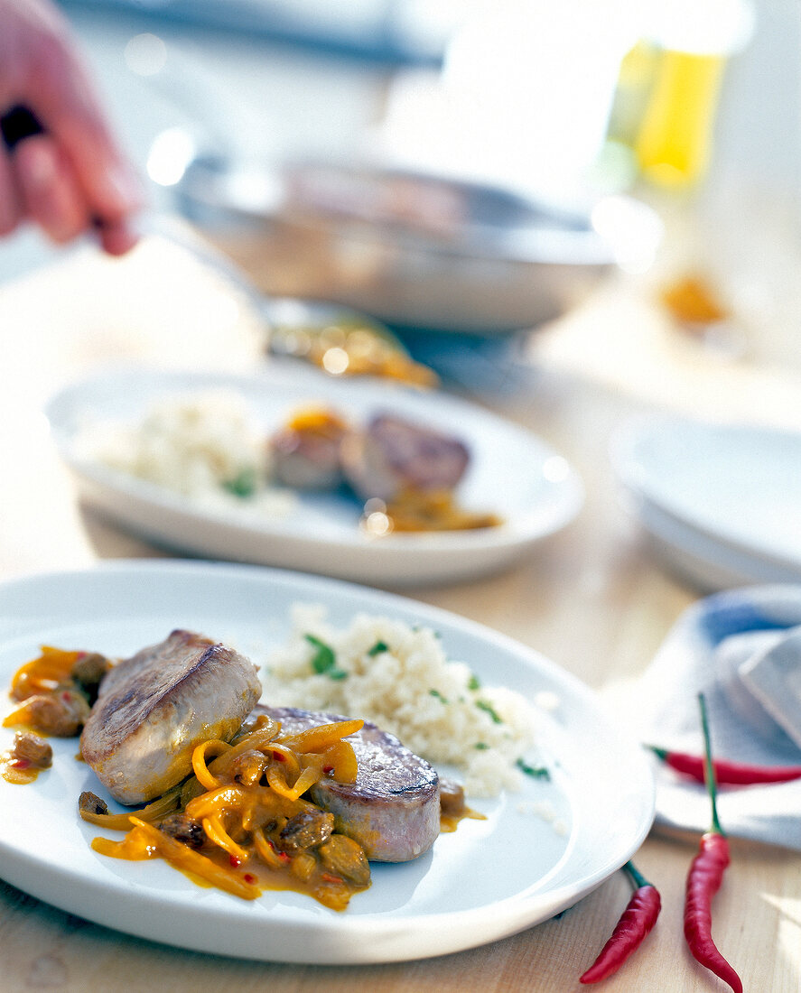 Pork medallions with couscous on plate