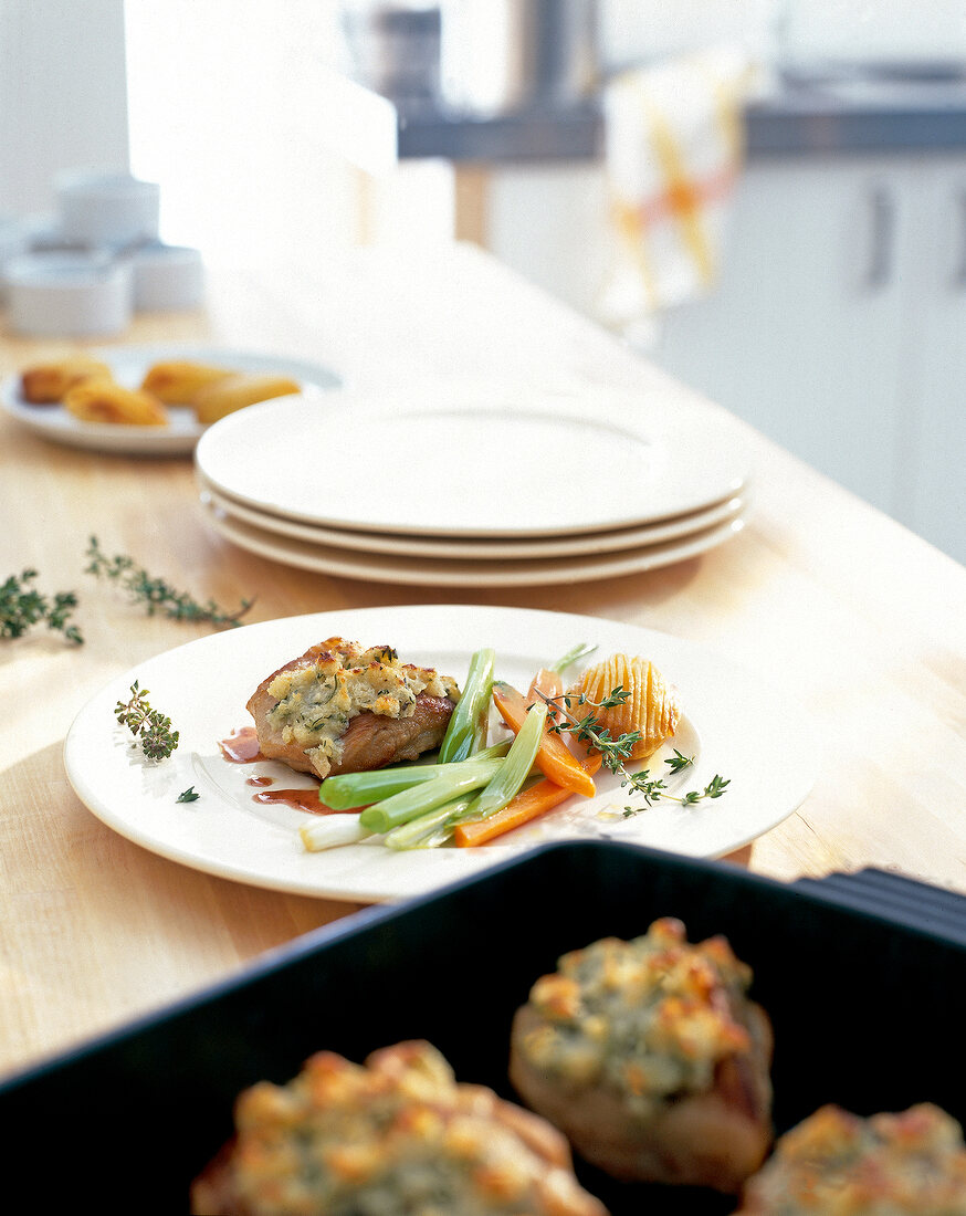 Gratin of pork cheeks on white plate